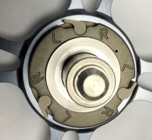 Close-up of a mechanical dial with directional indicators L, R, N, and a lock symbol.